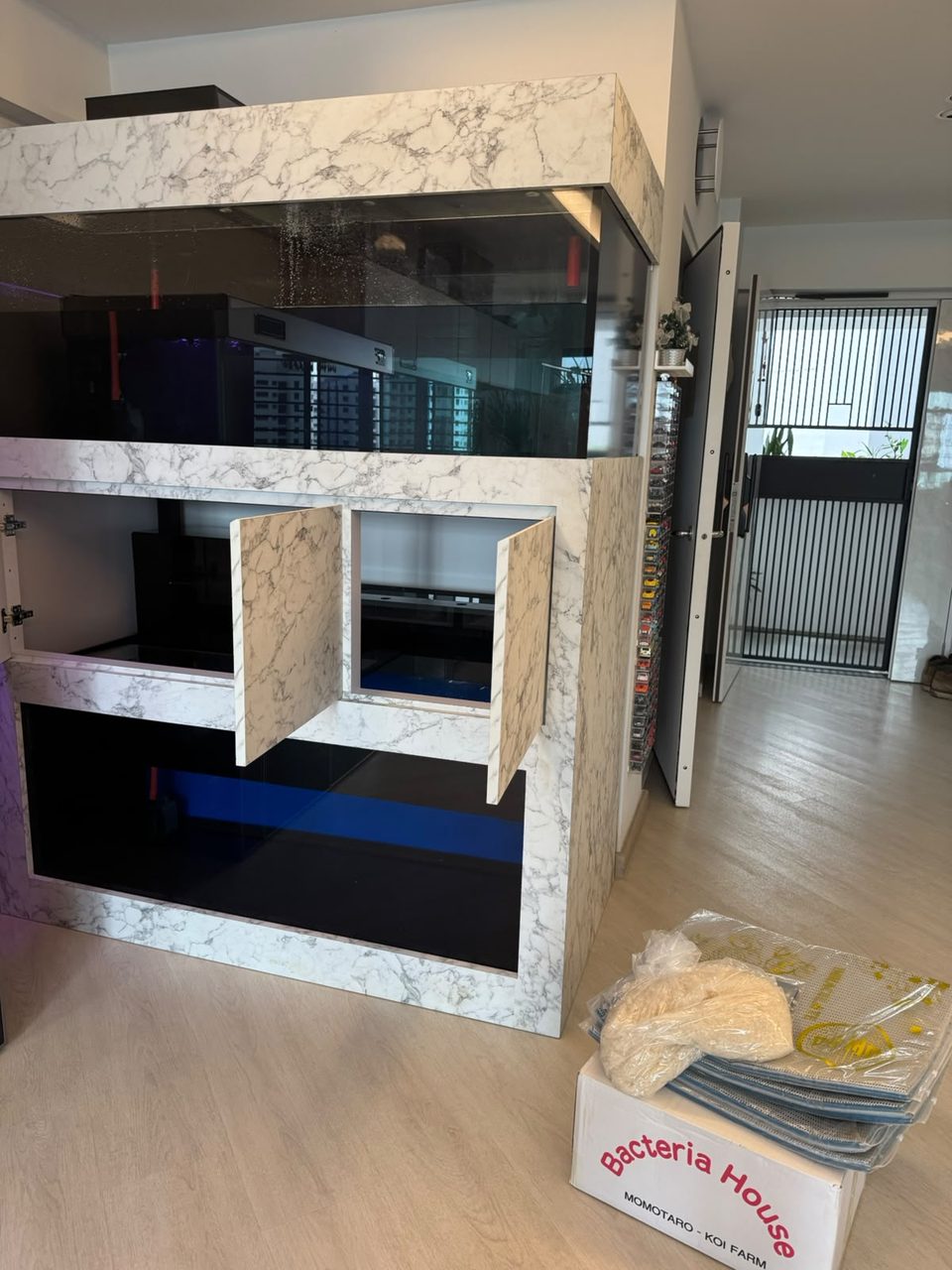 Cabinet doors open on the sump and storage below.